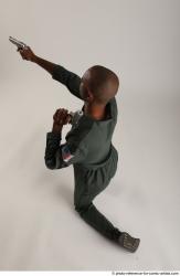 ERIC KNEELING POSE WITH GUNS